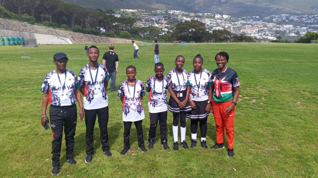 Kenya team members posing together on a field